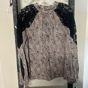 Cheetah & black lace blouse. Has a peep hole in the front. The sleeves have lace